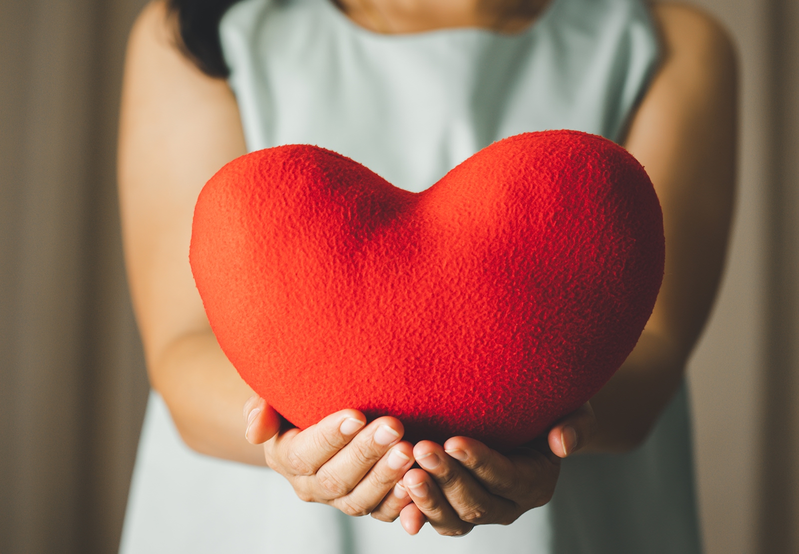 A women holding a heart plush