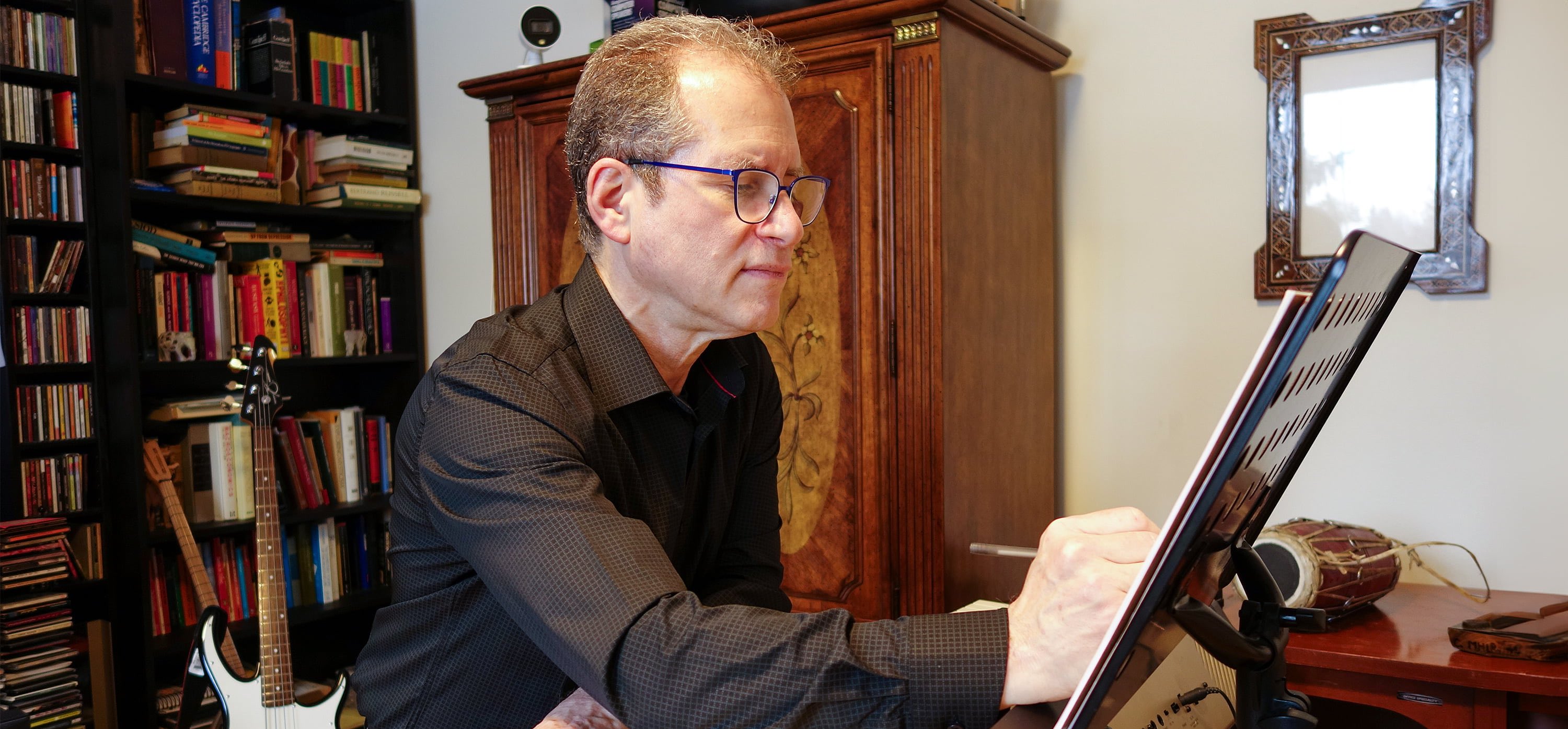 Music professor Michael Frishkopf on a keyboard making notes on his composition