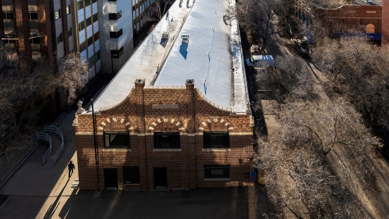 Students chatting around a table with pens and notebooks