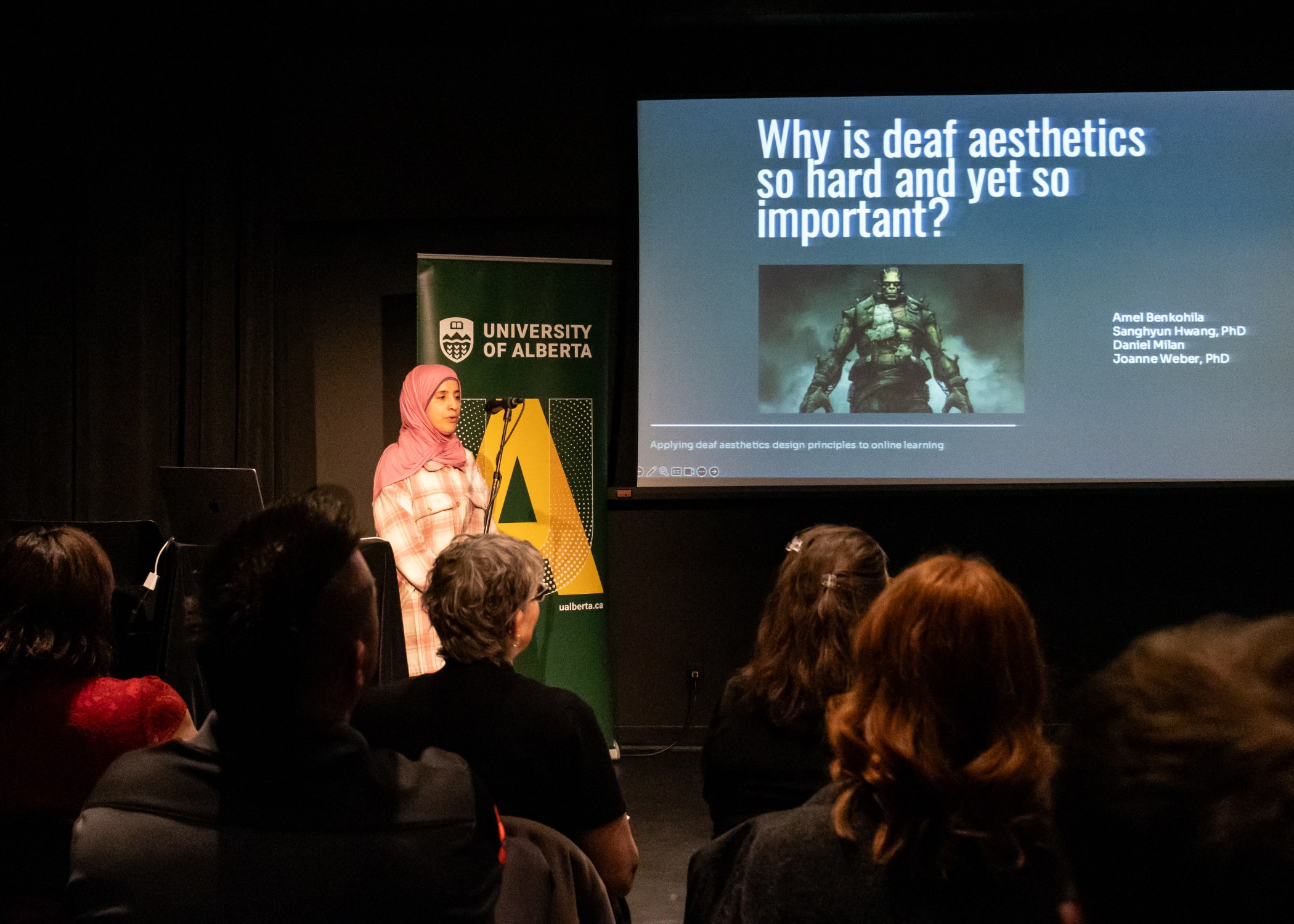 Amel Benkohila (Faculty of Education) presents while her advisor, Joanne Weber (Education), looks on